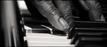 A black pianist plays jazz